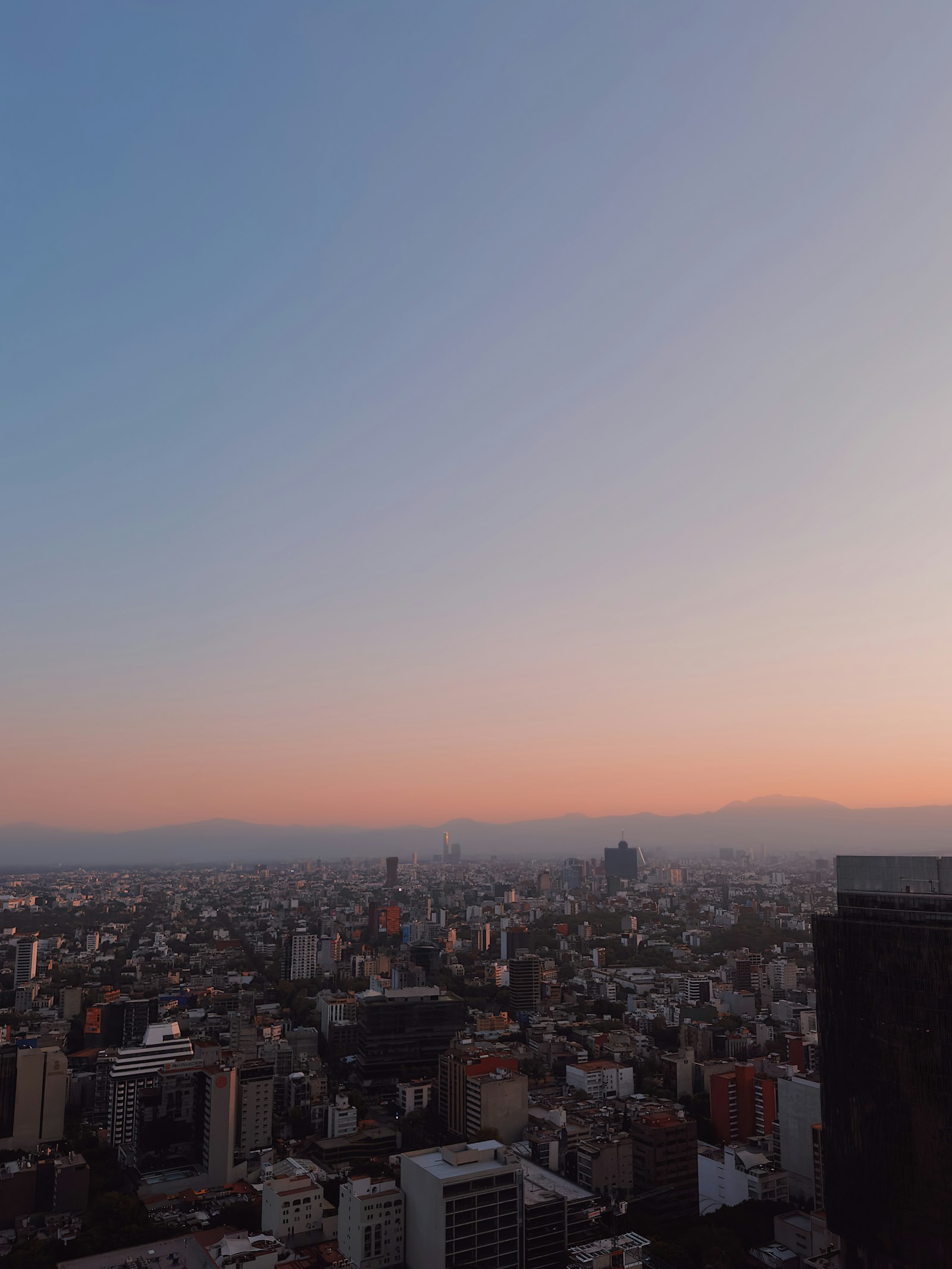 Mexico City skyline with high-rise residential towers at sunset